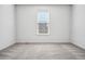 A bright bedroom with natural light and carpet flooring at 56582 E 23Rd Ave, Strasburg, CO 80136