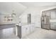 Bright kitchen features an island, stainless steel refrigerator, and an open layout for easy entertaining at 56582 E 23Rd Ave, Strasburg, CO 80136