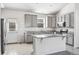 Stylish kitchen with gray cabinets, granite countertops, a center island, and stainless steel appliances at 56582 E 23Rd Ave, Strasburg, CO 80136