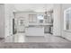 Modern kitchen featuring gray cabinets, stainless steel appliances, and a large center island at 56582 E 23Rd Ave, Strasburg, CO 80136