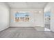 A well-lit living room with neutral tones and views of the outdoors at 56582 E 23Rd Ave, Strasburg, CO 80136