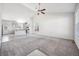 An open-concept living room with a high ceiling flows into the modern kitchen at 56582 E 23Rd Ave, Strasburg, CO 80136