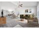 Bright living room featuring an open layout, vaulted ceiling, and neutral decor creating a cozy atmosphere at 56582 E 23Rd Ave, Strasburg, CO 80136