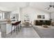 Open-concept living space with a seamless flow from the kitchen to a comfortable seating area at 56582 E 23Rd Ave, Strasburg, CO 80136