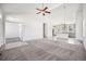 An open-concept living room with a high ceiling flows into the modern kitchen at 56582 E 23Rd Ave, Strasburg, CO 80136