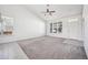 A bright living room with natural light, neutral tones, and a ceiling fan at 56582 E 23Rd Ave, Strasburg, CO 80136