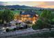 Panoramic aerial view of the estate, with a manicured yard and mountain views at 9650 S Cougar Rd, Littleton, CO 80127