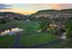 Aerial view of estate featuring luxury home, carriage house, sprawling lawns and mountain views at 9650 S Cougar Rd, Littleton, CO 80127