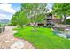 Beautifully landscaped backyard with lush lawn and stone retaining walls, providing a private outdoor retreat at 9650 S Cougar Rd, Littleton, CO 80127