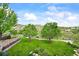 Lush backyard featuring a stone water feature and mountain views at 9650 S Cougar Rd, Littleton, CO 80127