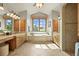Bright bathroom with double vanities, a soaking tub, and picturesque views at 9650 S Cougar Rd, Littleton, CO 80127