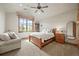 Cozy bedroom featuring vaulted ceilings, a ceiling fan, and scenic views at 9650 S Cougar Rd, Littleton, CO 80127