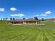 Carriage house with multiple garage bays and a well-manicured lawn at 9650 S Cougar Rd, Littleton, CO 80127