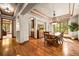 Formal dining room featuring elegant chandelier, wood floors, and beautiful natural light at 9650 S Cougar Rd, Littleton, CO 80127