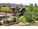 Beautiful home with landscaped grounds, stone accents, and multiple patios at 9650 S Cougar Rd, Littleton, CO 80127
