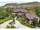 Beautiful exterior of this stunning property features mature trees and lush landscaping at 9650 S Cougar Rd, Littleton, CO 80127