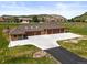 Expansive six-car garage with a circle driveway and mountain views, offering ample parking and scenic surroundings at 9650 S Cougar Rd, Littleton, CO 80127