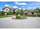 Beautiful home featuring landscaped circular drive and stone detailing at 9650 S Cougar Rd, Littleton, CO 80127