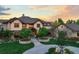 Beautiful front yard with circular driveway, stone accents and lush landscaping at 9650 S Cougar Rd, Littleton, CO 80127