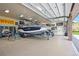 Spacious garage equipped with a boat on a trailer, overhead storage, and ample workspace at 9650 S Cougar Rd, Littleton, CO 80127