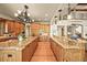 Expansive kitchen featuring custom wood cabinets, granite countertops, and modern appliances at 9650 S Cougar Rd, Littleton, CO 80127