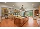 Gourmet kitchen with a double island, wood floors, stone fireplace and breakfast nook with views at 9650 S Cougar Rd, Littleton, CO 80127
