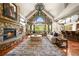 Spacious living room with stone fireplace, vaulted ceilings, hardwood floors and mountain views at 9650 S Cougar Rd, Littleton, CO 80127