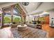 Open living room with high ceilings, large windows, and views of the kitchen at 9650 S Cougar Rd, Littleton, CO 80127