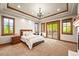 Spacious main bedroom with natural light, a private balcony, and wood trim at 9650 S Cougar Rd, Littleton, CO 80127