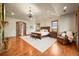 Spacious primary bedroom features a stone fireplace, chandelier, and wood floors at 9650 S Cougar Rd, Littleton, CO 80127