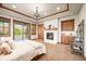 Elegant main bedroom featuring fireplace, balcony, and a convenient beverage bar at 9650 S Cougar Rd, Littleton, CO 80127