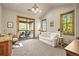 Bright office features a comfortable couch, desk, and access to a private balcony at 9650 S Cougar Rd, Littleton, CO 80127