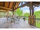 Covered patio with stone columns and outdoor seating area showcasing scenic views at 9650 S Cougar Rd, Littleton, CO 80127
