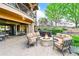 Back patio with comfortable seating around a stone fire pit and hot tub at 9650 S Cougar Rd, Littleton, CO 80127
