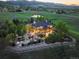 Aerial view showcases tiered patio, outdoor fireplace and entertainment area overlooking mountain scenery at 9650 S Cougar Rd, Littleton, CO 80127