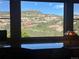Spectacular mountain views from a large window; an inspiring vista adds natural beauty and tranquility to this home at 9650 S Cougar Rd, Littleton, CO 80127