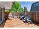 Outdoor backyard with a gas grill, cozy seating, and an open backyard deck with a wooden fence at 11402 W 17Th Pl, Lakewood, CO 80215