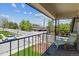 Outdoor Balcony with seating that overlooks a residential neighborhood street and landscape at 11402 W 17Th Pl, Lakewood, CO 80215