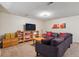Bright and spacious finished basement features a TV, open shelving, comfortable seating and decorative accents at 11402 W 17Th Pl, Lakewood, CO 80215