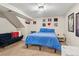 Bright bedroom with soft carpet, featuring a blue bed, futon, and artistic wall decor for a cozy feel at 11402 W 17Th Pl, Lakewood, CO 80215