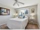 Cozy bedroom with a soft carpet, complemented by a ceiling fan and natural light from the window at 11402 W 17Th Pl, Lakewood, CO 80215