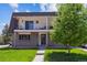 Two-story home featuring two balconies, a manicured lawn, and traditional design at 11402 W 17Th Pl, Lakewood, CO 80215