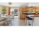 Bright kitchen featuring wood cabinets, an island, and a dining area, perfect for Gathering meals at 11402 W 17Th Pl, Lakewood, CO 80215