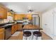 Charming kitchen featuring stainless steel appliances, wood cabinets, and an island with seating at 11402 W 17Th Pl, Lakewood, CO 80215