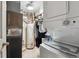 Utility room with laundry area, water heater, and storage for cleaning supplies at 11402 W 17Th Pl, Lakewood, CO 80215