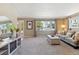 Inviting living room with ample natural light, plush carpet, and stylish furnishings at 11402 W 17Th Pl, Lakewood, CO 80215