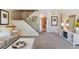 Open living room showcasing the staircase, entry to kitchen and comfortable seating arrangement at 11402 W 17Th Pl, Lakewood, CO 80215