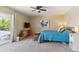 Comfortable main bedroom with a ceiling fan, large windows, and access to a private balcony at 11402 W 17Th Pl, Lakewood, CO 80215