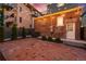 Charming brick-paved backyard illuminated by string lights, perfect for evening relaxation at 1730 N Gaylord St, Denver, CO 80206