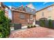 Enchanting backyard patio with string lights highlighting the brick and landscaped details at 1730 N Gaylord St, Denver, CO 80206